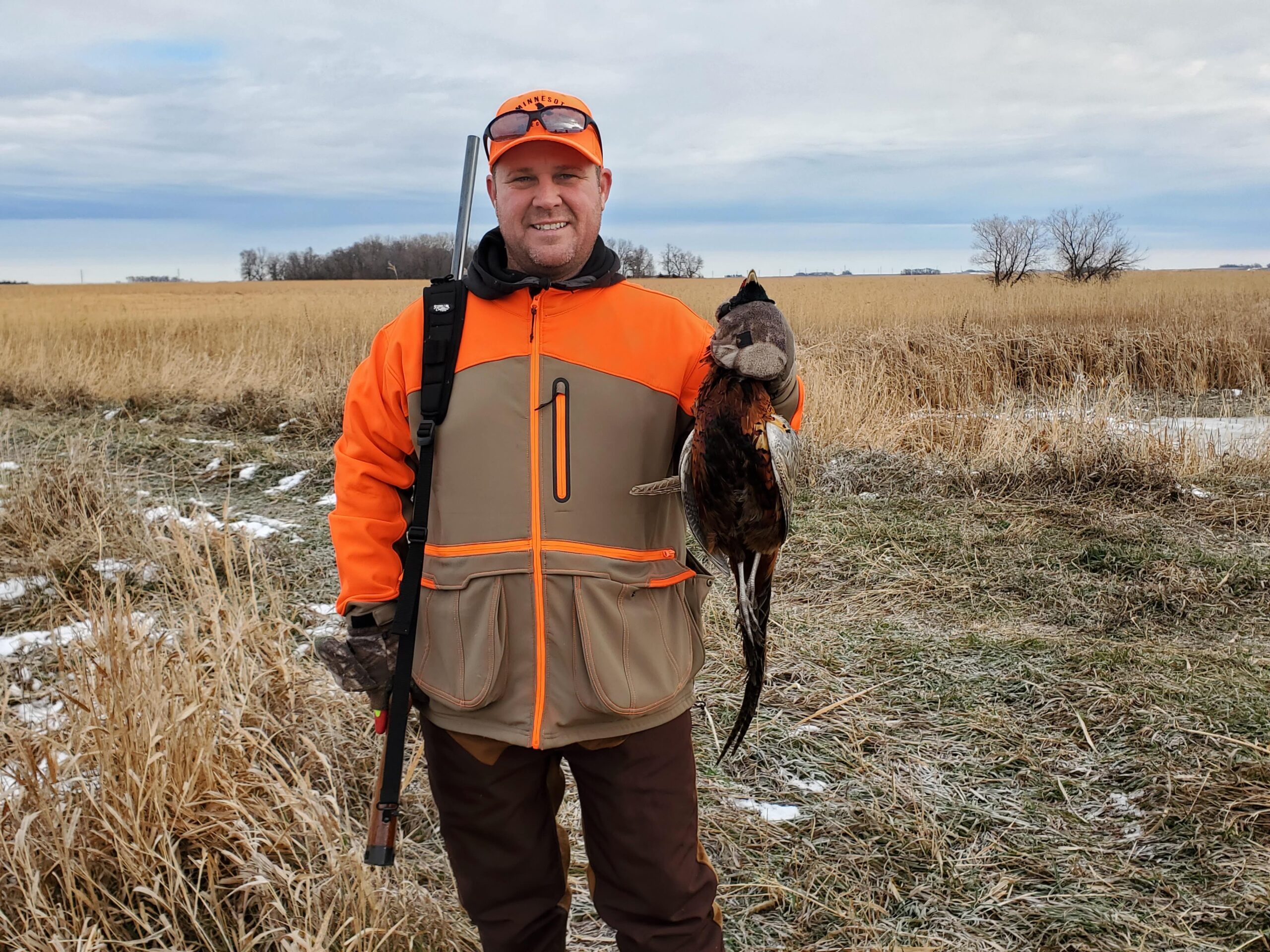 Mike Holding a successfully harvested pheasant.